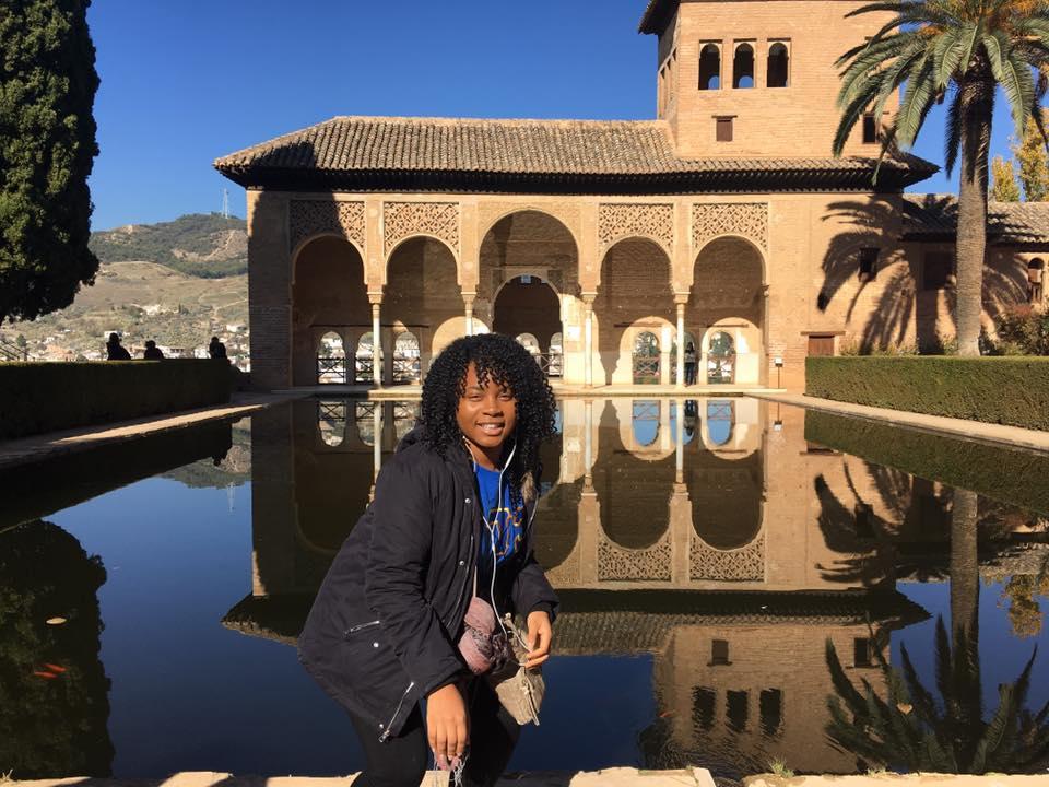 Student posing outside a castle